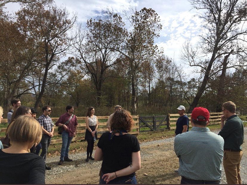 [L to R] Jack Bouchard, Jonathan MacDonald, and Taylor Johnson gather on Smith Meadows Sustainable Farm in Virginia with participants in the Folger Institute seminar “Digging the Past: Writing and Agriculture in the Seventeenth Century.”