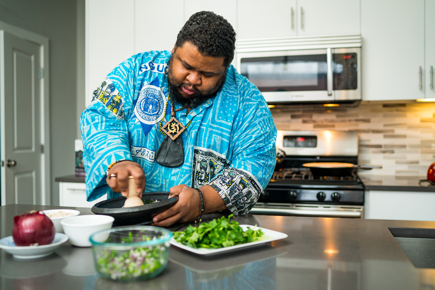 Culinary historian, food writer, and living history interpreter Michael W. Twitty prepares the ingredients for akara.