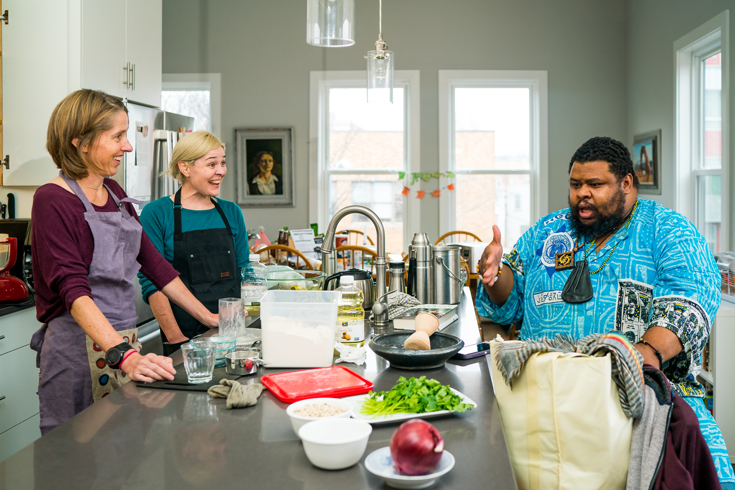 [L to R] Heather Wolfe, Amanda Herbert, and Michael W. Twitty share a moment of laughter as they cook akara.