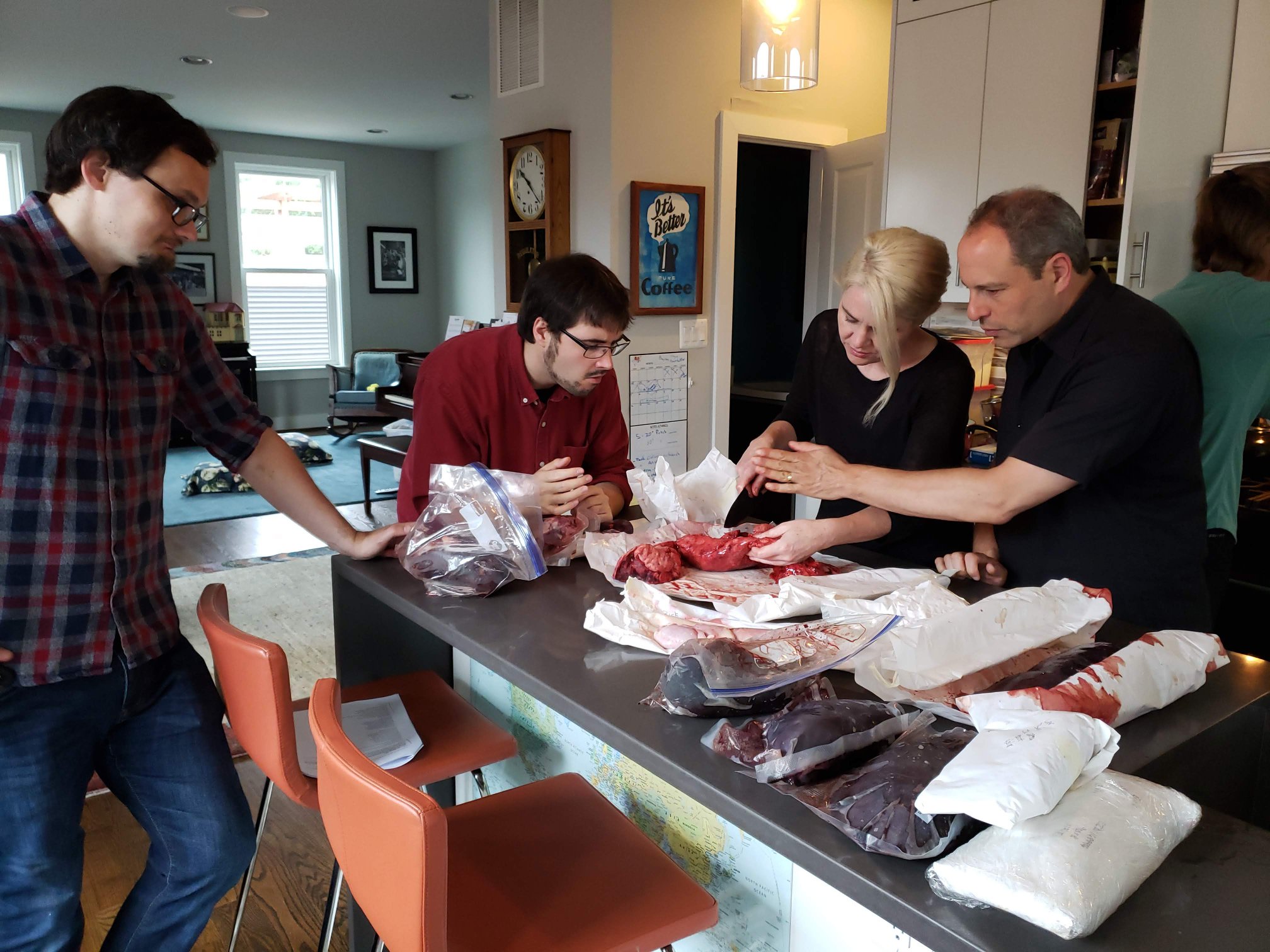 [L to R] Michael Walkden, Jack Bouchard, Amanda Herbert, and David Goldstein discuss butchering while making a popular early modern dish, humble pie.
